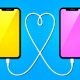 Two phones are connected with a wire in the shape of a heart